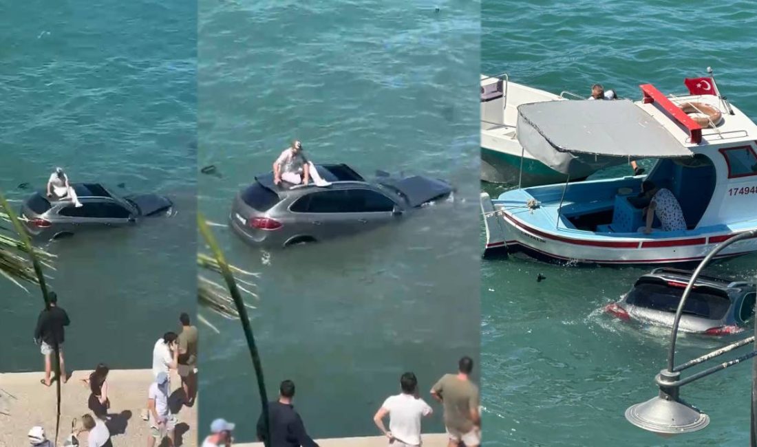 Balıkesir'in Ayvalık ilçesinde sürücüsü denizin içinde batmakta olan otomobilin üzerinde