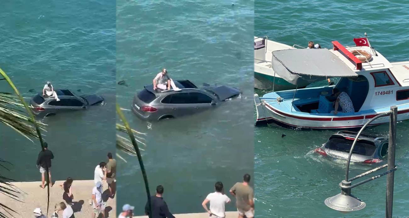 Balıkesir'in Ayvalık ilçesinde sürücüsü denizin içinde batmakta olan otomobilin üzerinde